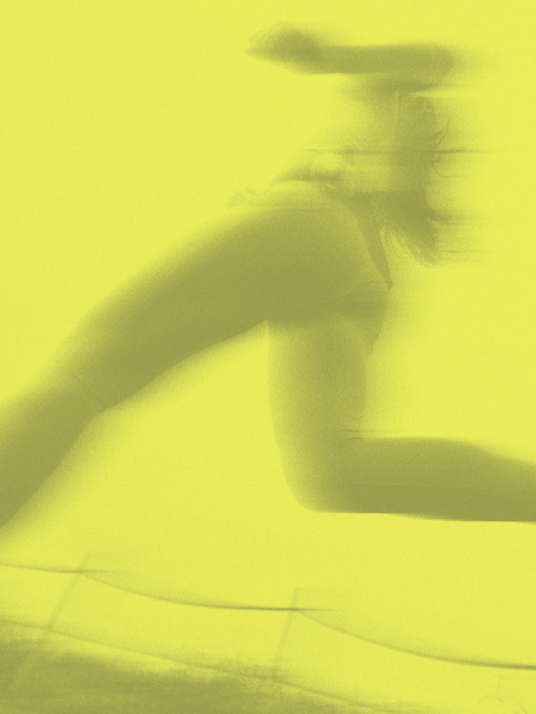 Motion-blurred silhouette of a runner mid-stride against a bright neon yellow background.